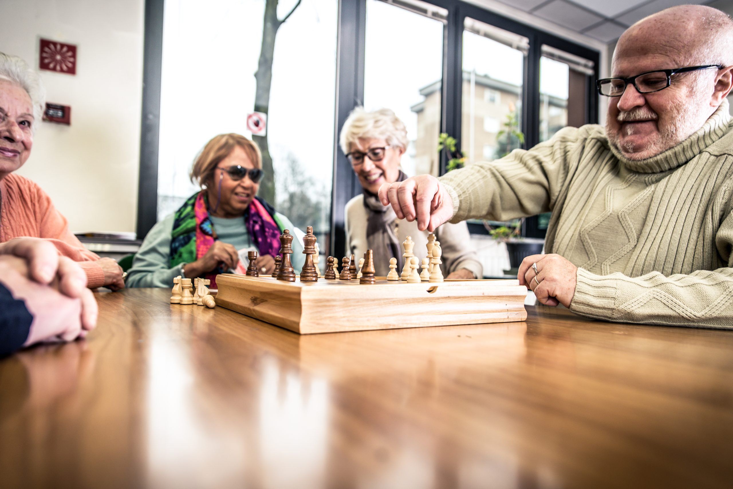 Group of seniors making activities inside the hospice